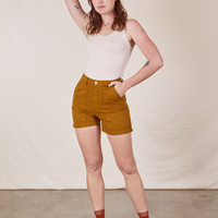 Alex is 5'8" and wearing size XS Classic Work Shorts in Spicy Mustard paired with vintage off-white Tank Top