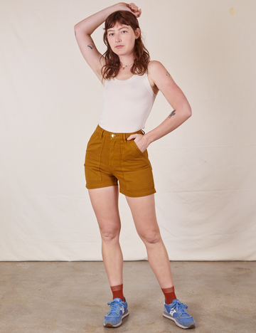 Alex is 5'8" and wearing size XS Classic Work Shorts in Spicy Mustard paired with vintage off-white Tank Top