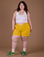 Ashley is 5’7” and wearing 1XL Classic Work Shorts in Sunshine Yellow paired with Vintage Tee White Cropped Tank