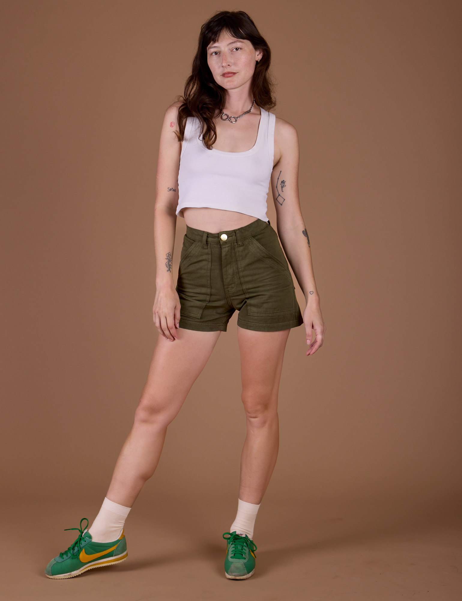 Alex is 5’8” and wearing XXS Classic Work Shorts in Surplus Green paired with a vintage off white Cropped Tank