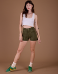 Alex is 5’8” and wearing XXS Classic Work Shorts in Surplus Green paired with a vintage off white Cropped Tank