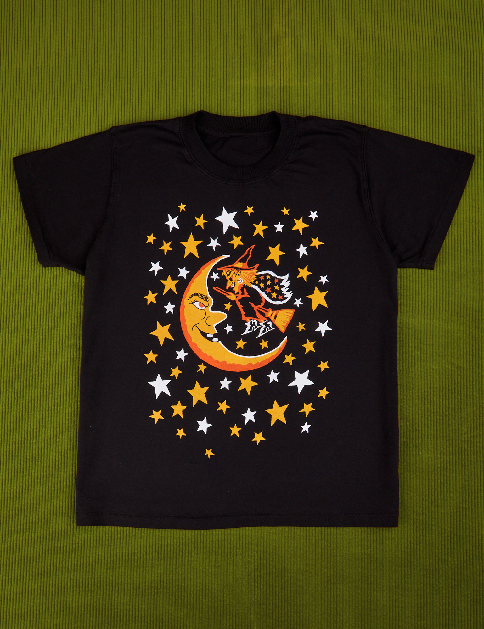 Vintage Tee in Moon & Witch. Black tee body with yellow and white stars surrounding a moon and witch