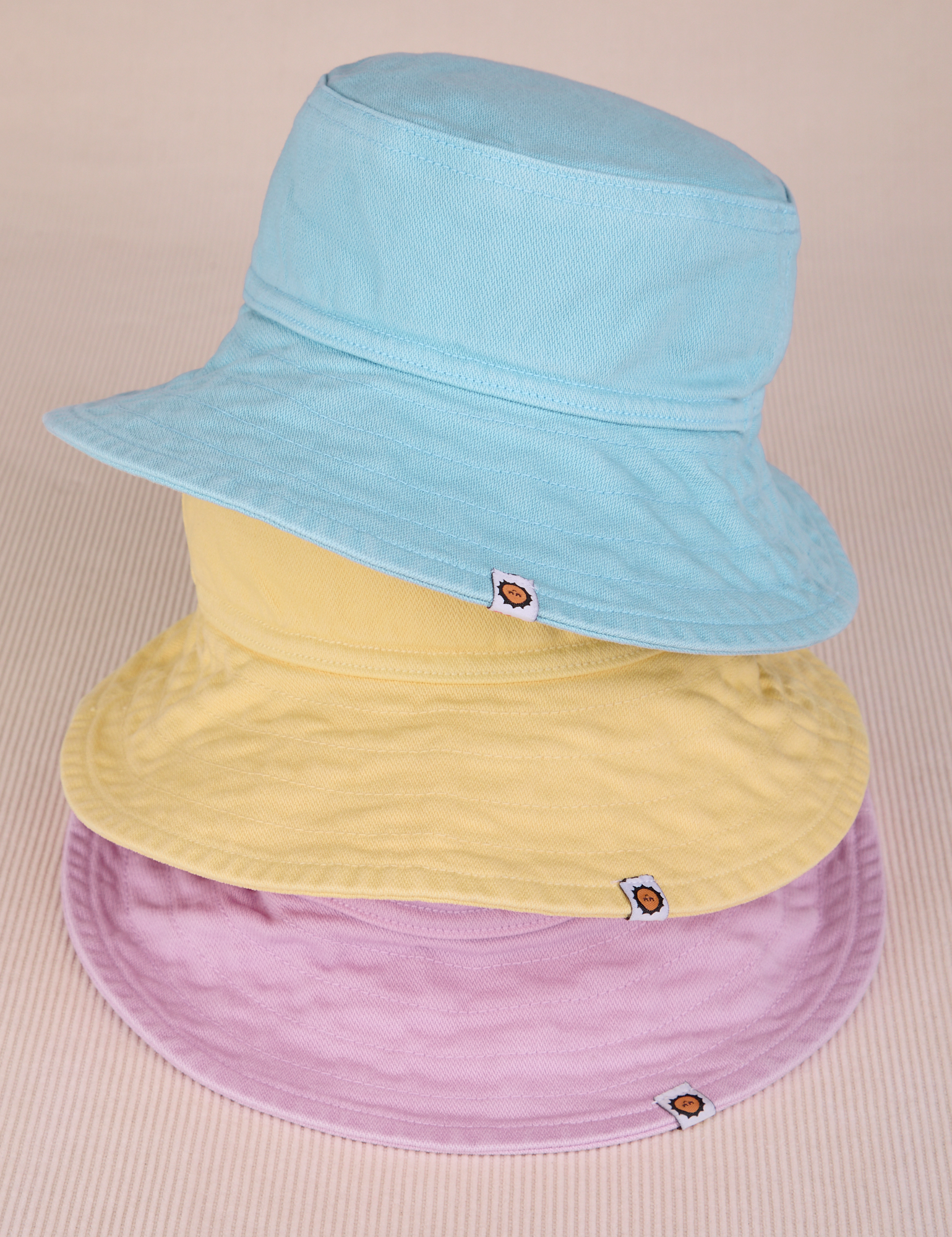 Stacked Wide Brim Denim Bucket Hats in lilac, butter yellow and baby blue