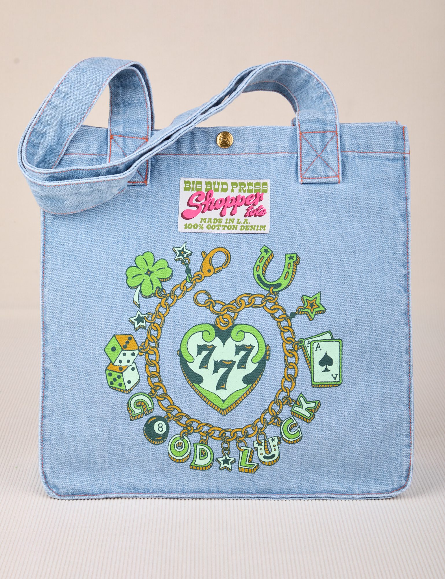 Shopper Tote in Lucky Charm - Screenprinted charm bracelet with a clover, horseshoe, dice, Ace, and Good Luck.