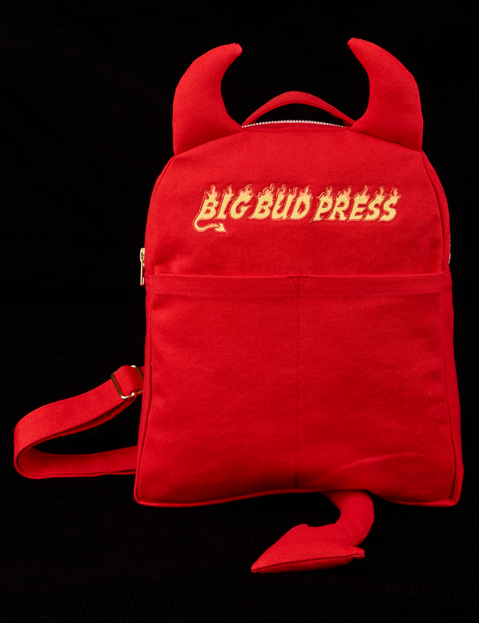 Devil Backpack - Red Mini Backpack with horns and a tail. Big Bud Press embroidered on front in yellow.