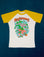 White body with yellow sleeves. Mushroom graphic at center of tee.