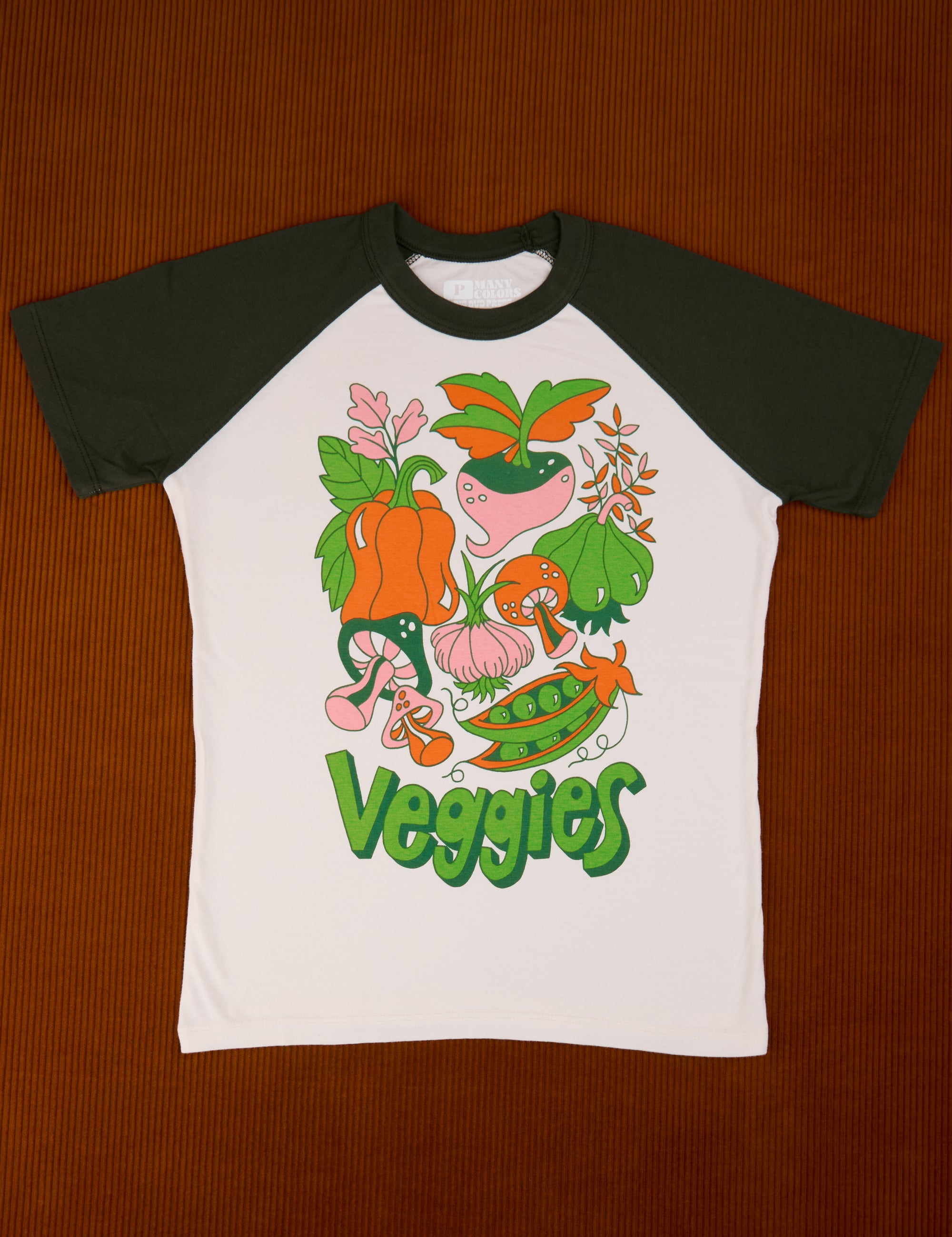 White body tee with dark green sleeves. Graphic of an array of veggies in the middle of the tee.