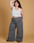 Ashley is 5'7" and wearing 1XL Heritage Wide Leg Trousers in Washed Grey paired with a vintage tee white Cropped Tank