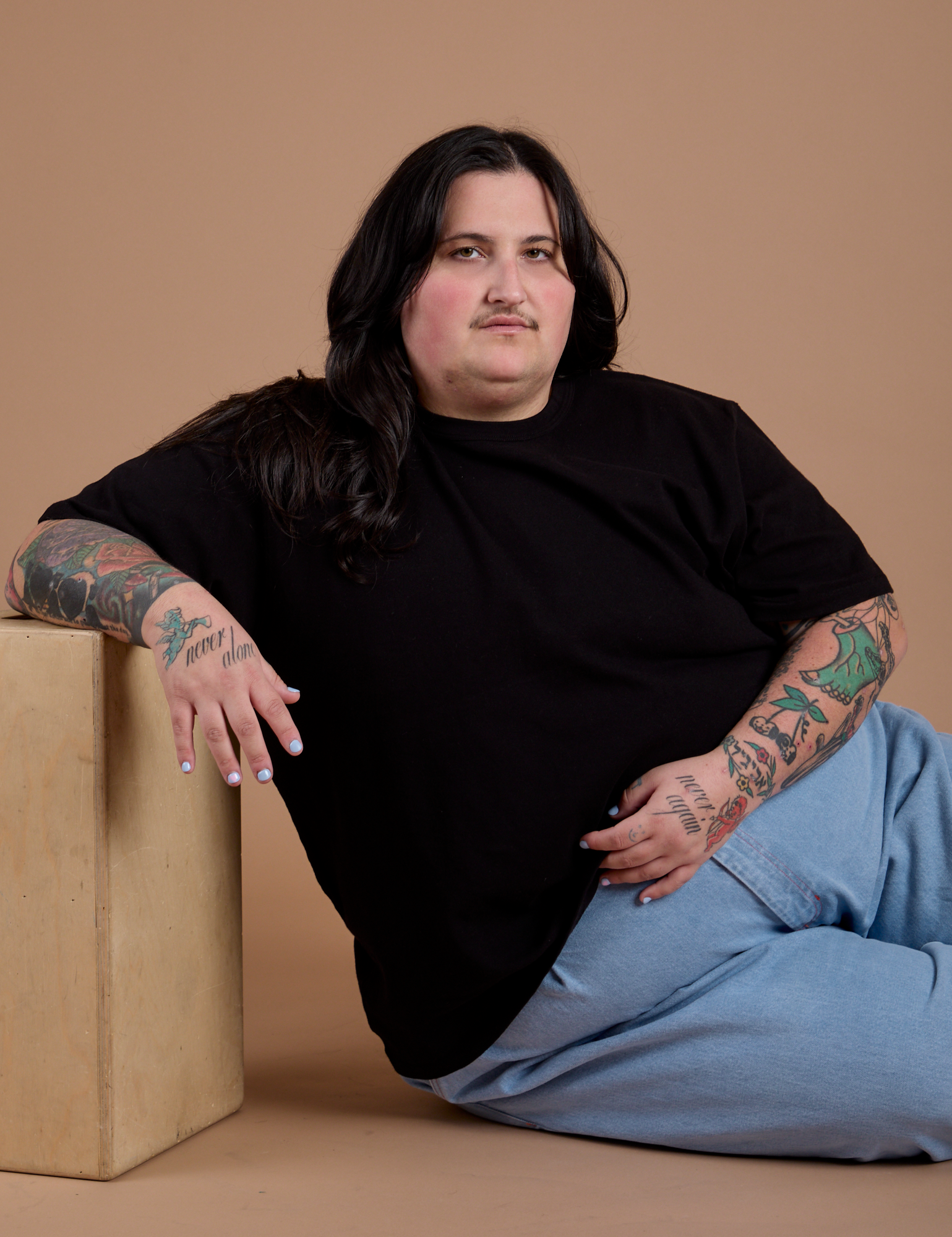 Sam is wearing Burly Tee in Basic Black