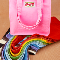 Shopper Tote Bag in a rainbow of hues. Bubblegum pink colorway on top of stack of all other colors.