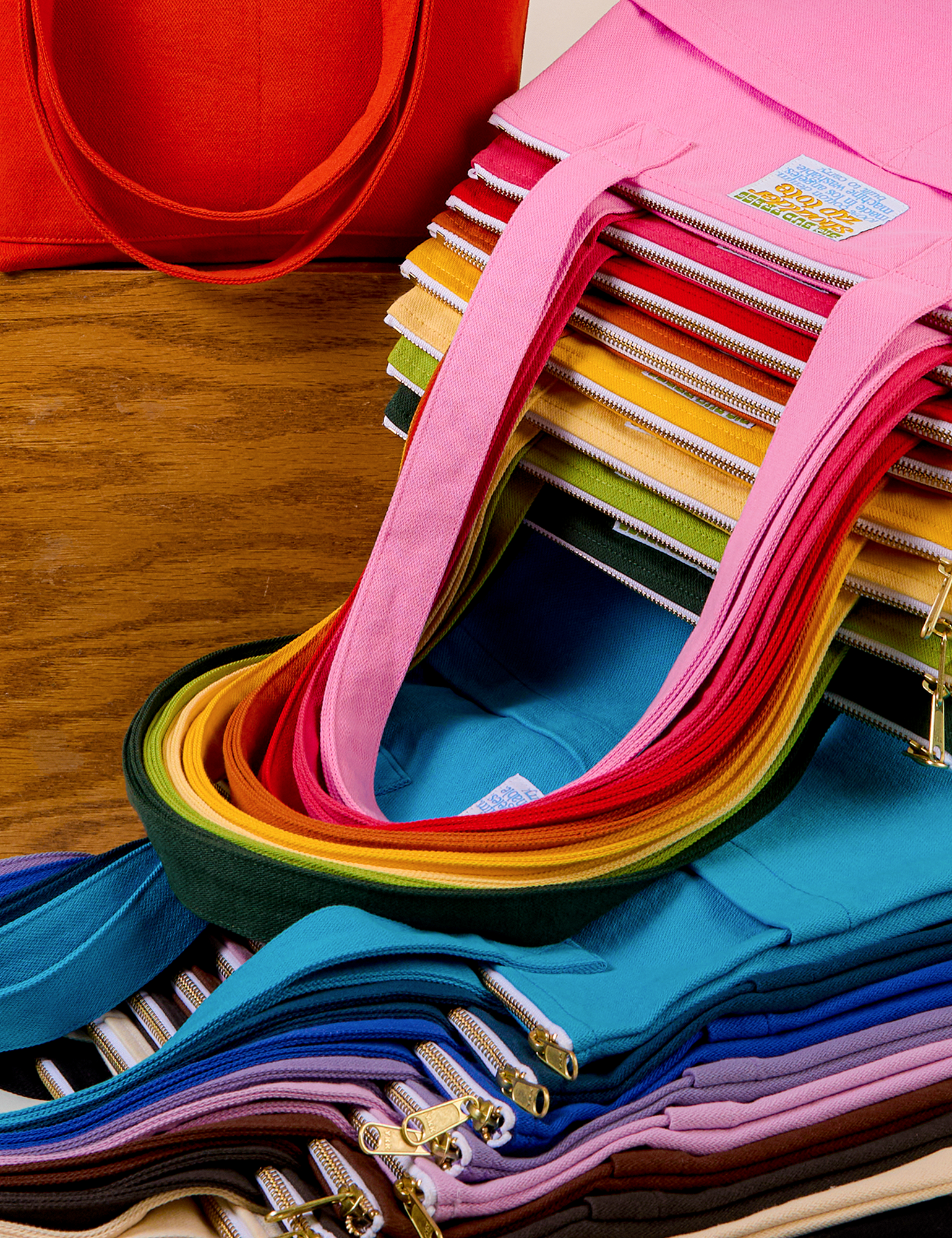 A rainbow of stacked Over-Shoulder Zip Mini Tote