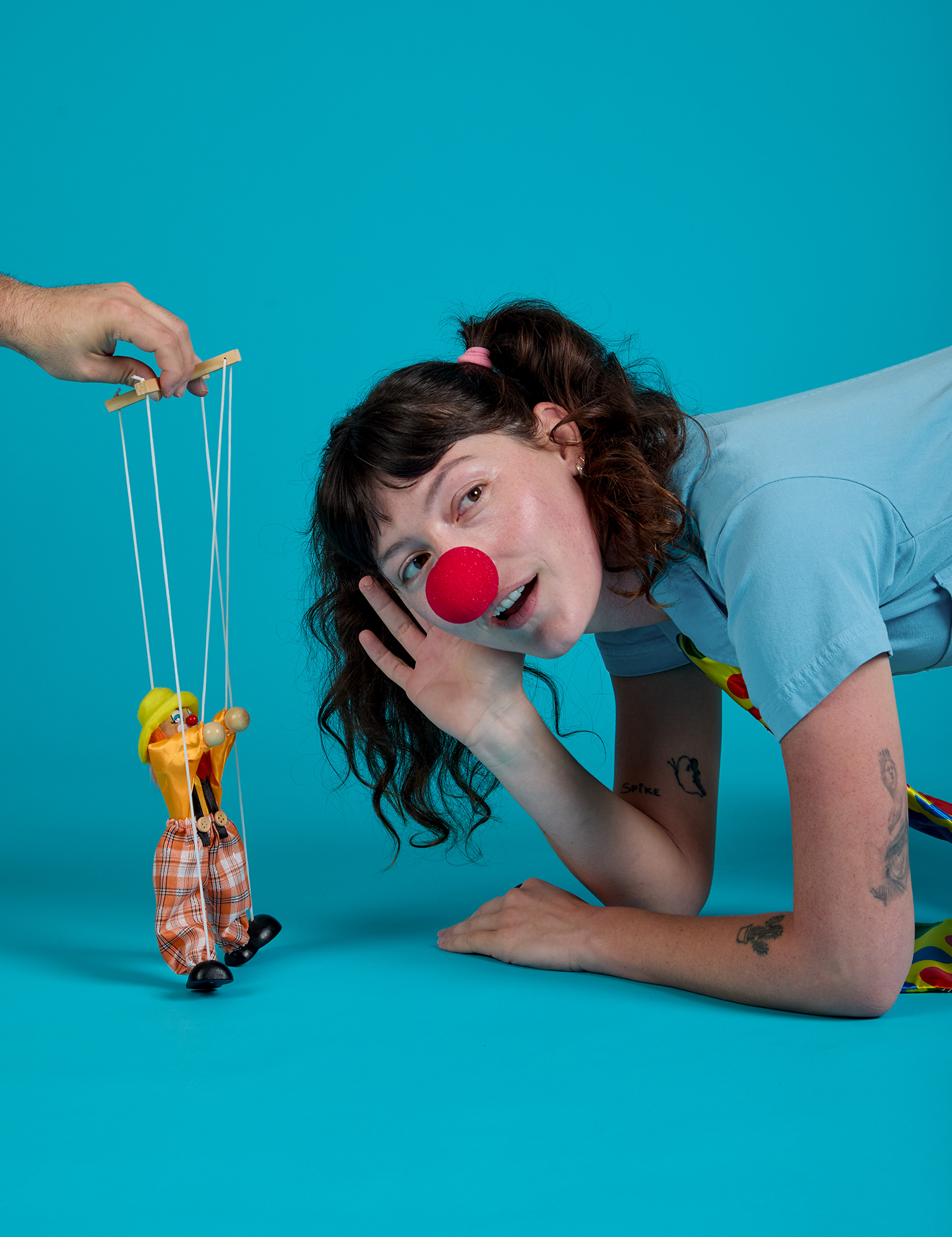 Short Sleeve Jumpsuit in Baby Blue on Alex with a red clown nose