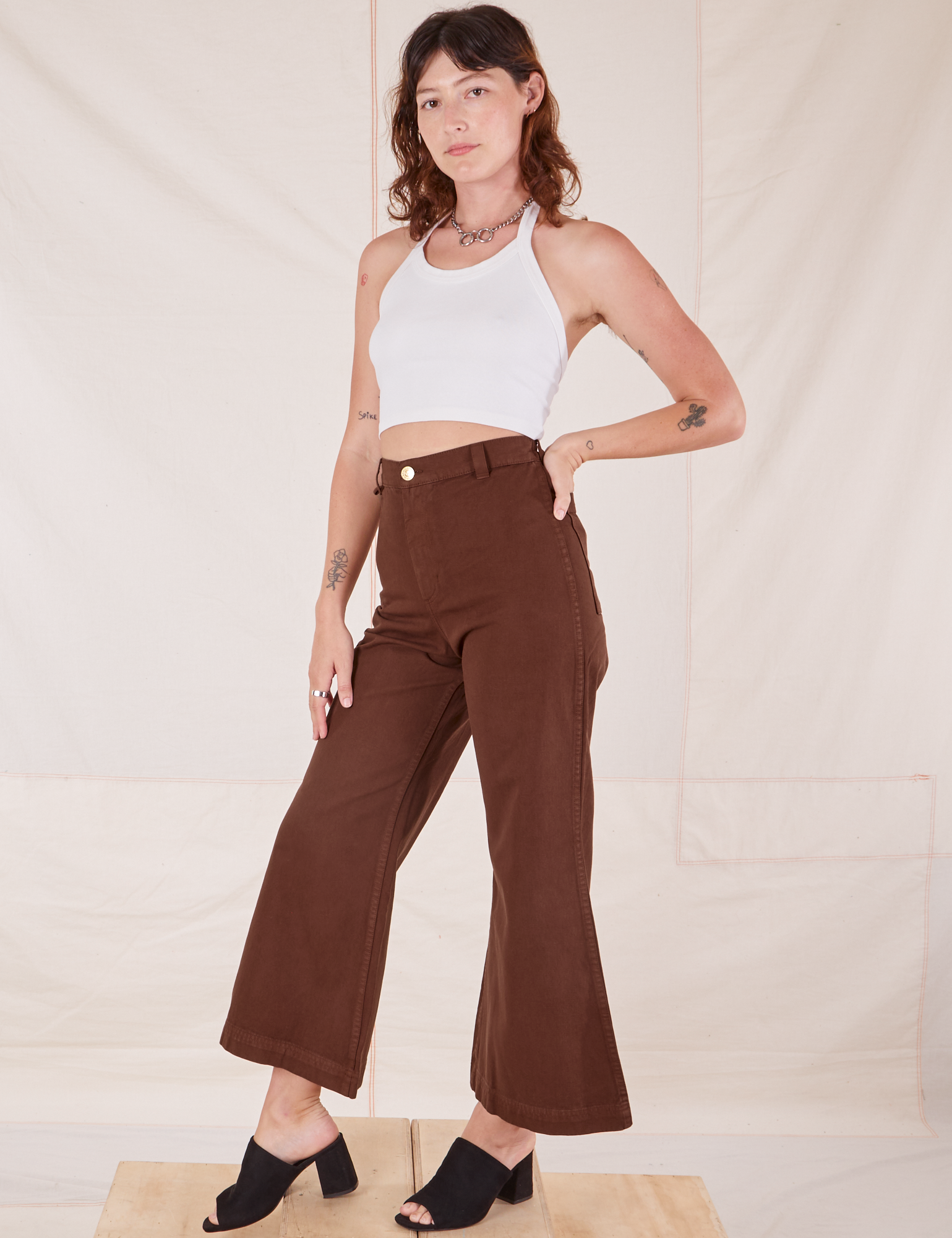 Angled view of Bell Bottoms in Fudgesicle Brown and vintage off-white Halter Top on Alex