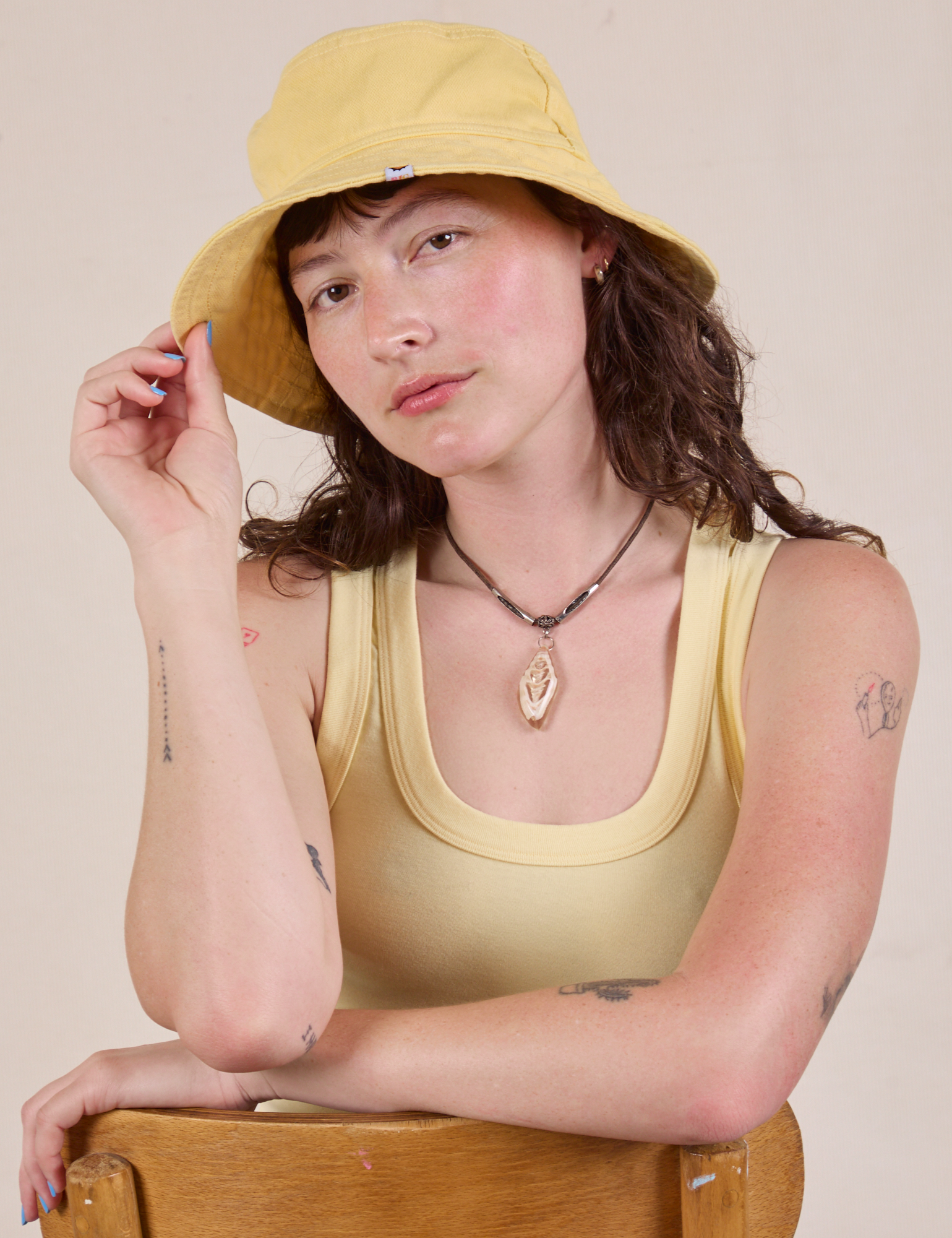 Alex is wearing the butter yellow Wide Brim Denim Bucket Hat