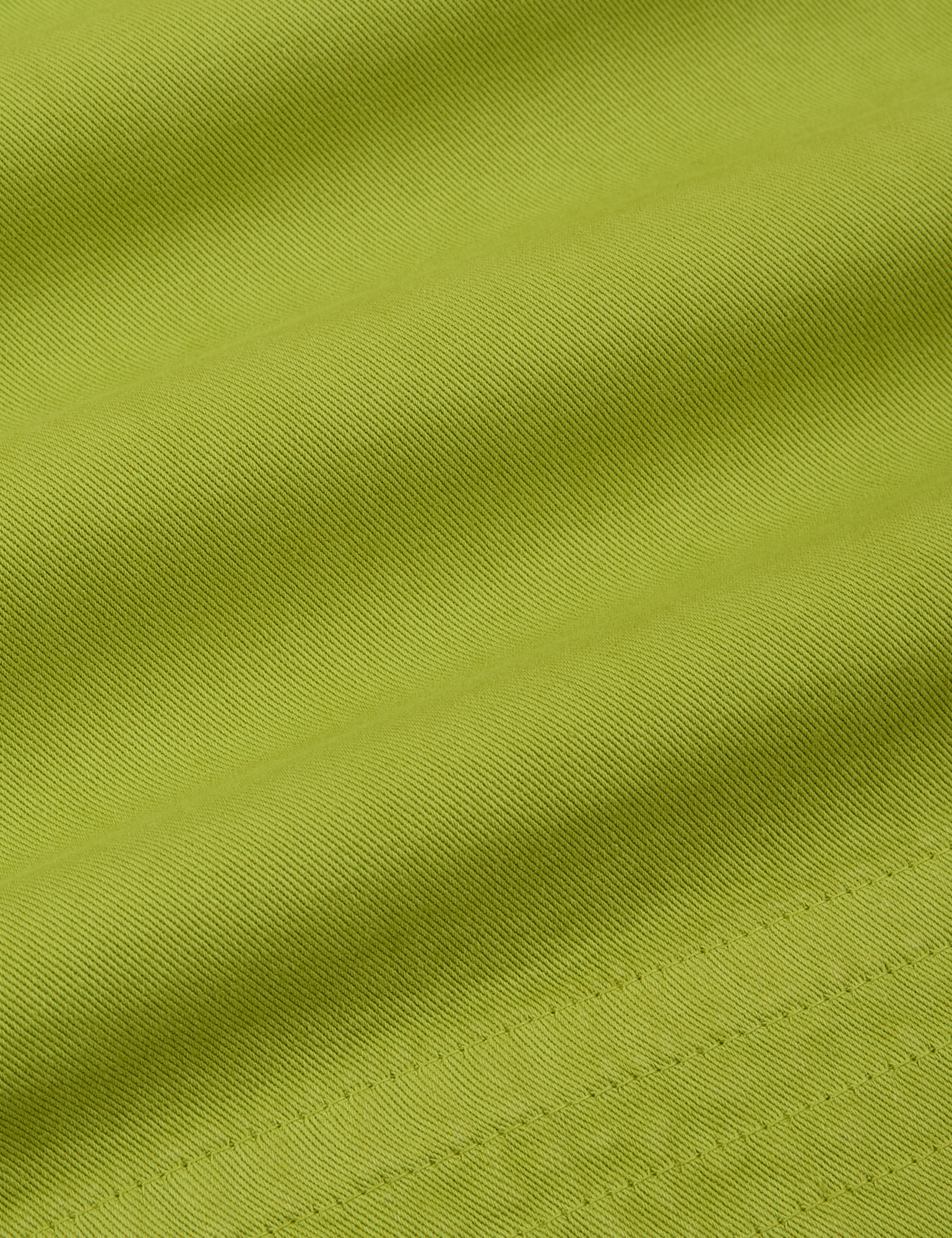 Action Pants in Gross Green fabric detail close up