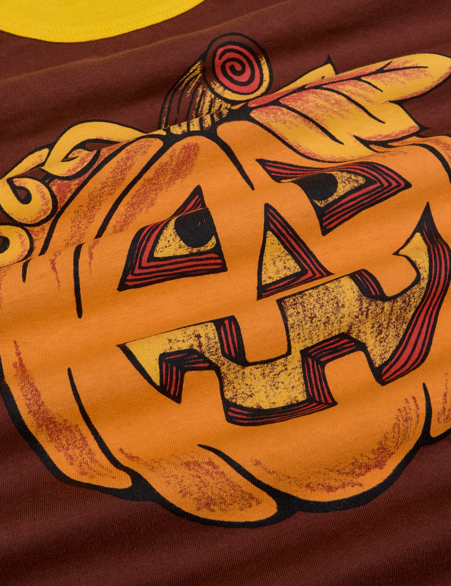 Close up of screenprinted orange jack-o-lantern