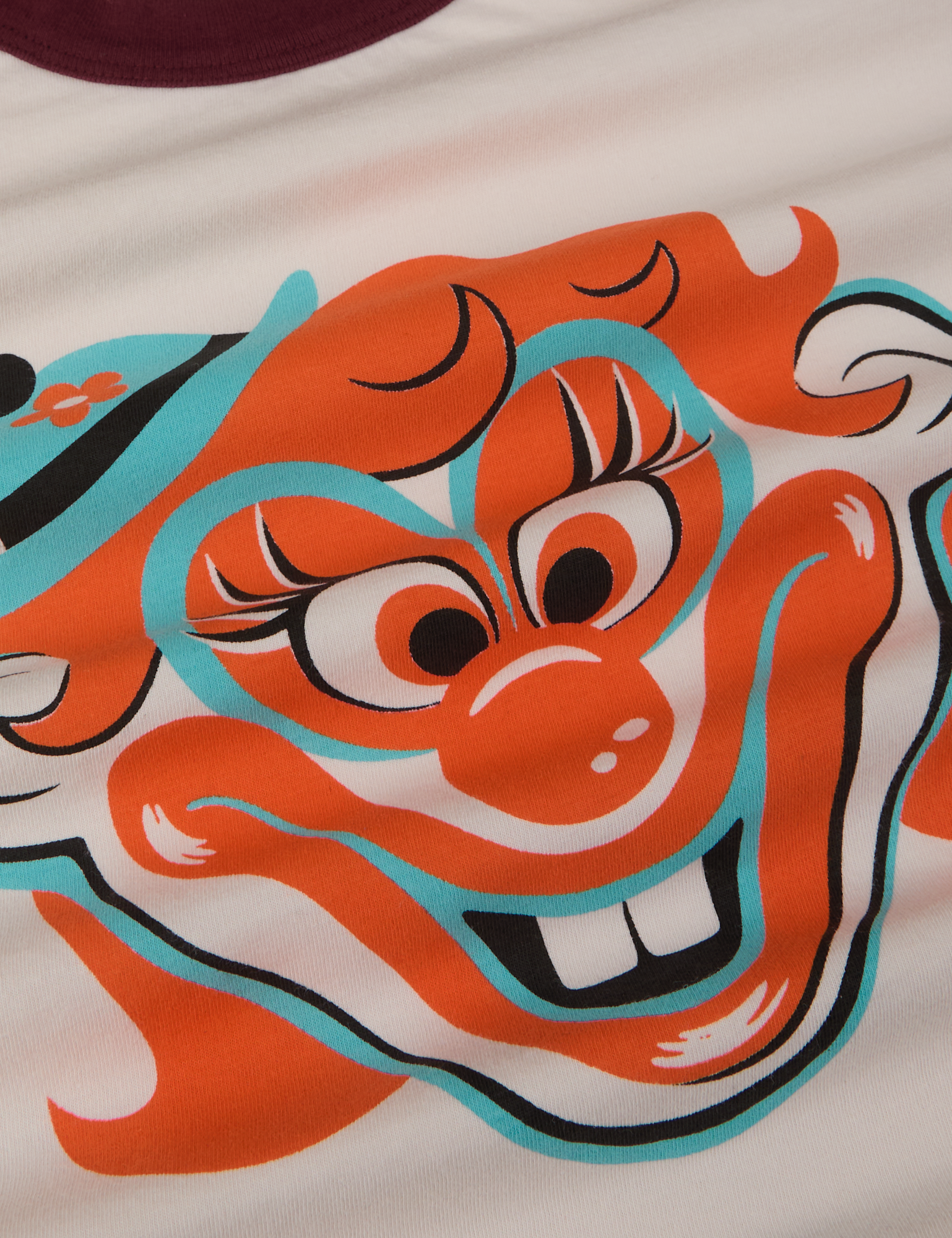Close up of clown face in orange, blue and black