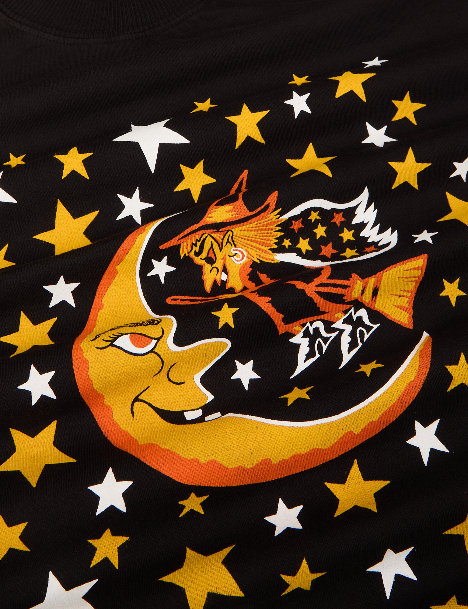 Close up of the yellow and white stars, yellow and orange moon and witch