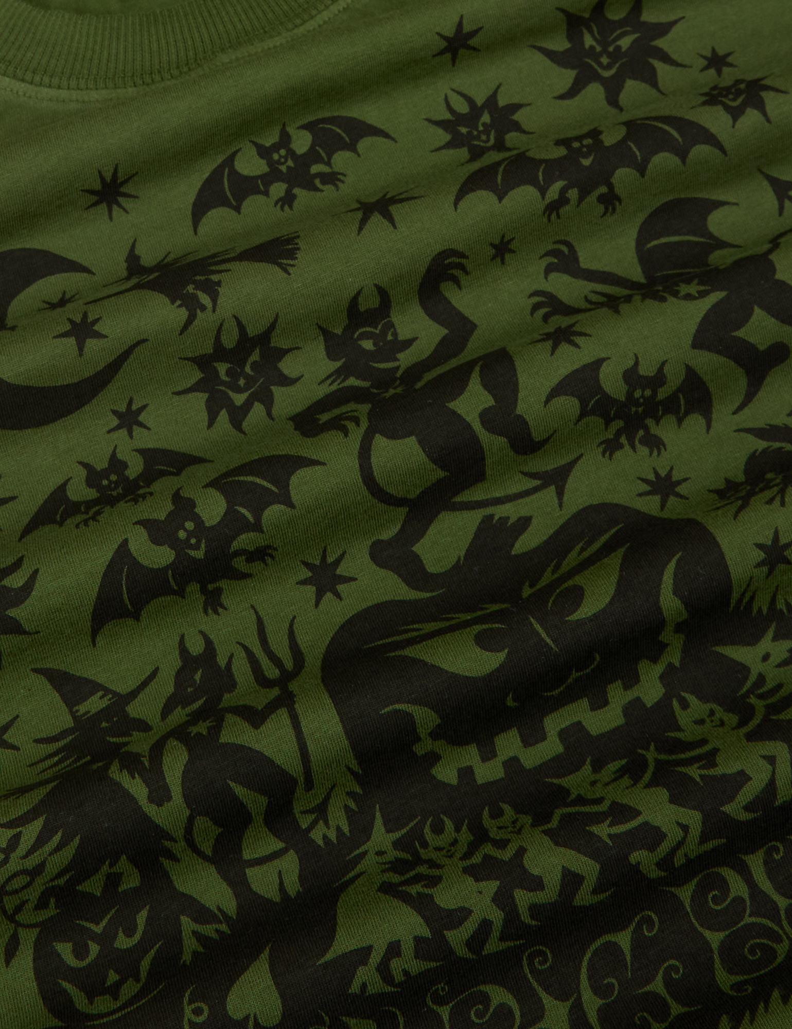 Close up of black graphic of pumpkin, devils, a witch, scarecrow bats and the moon.