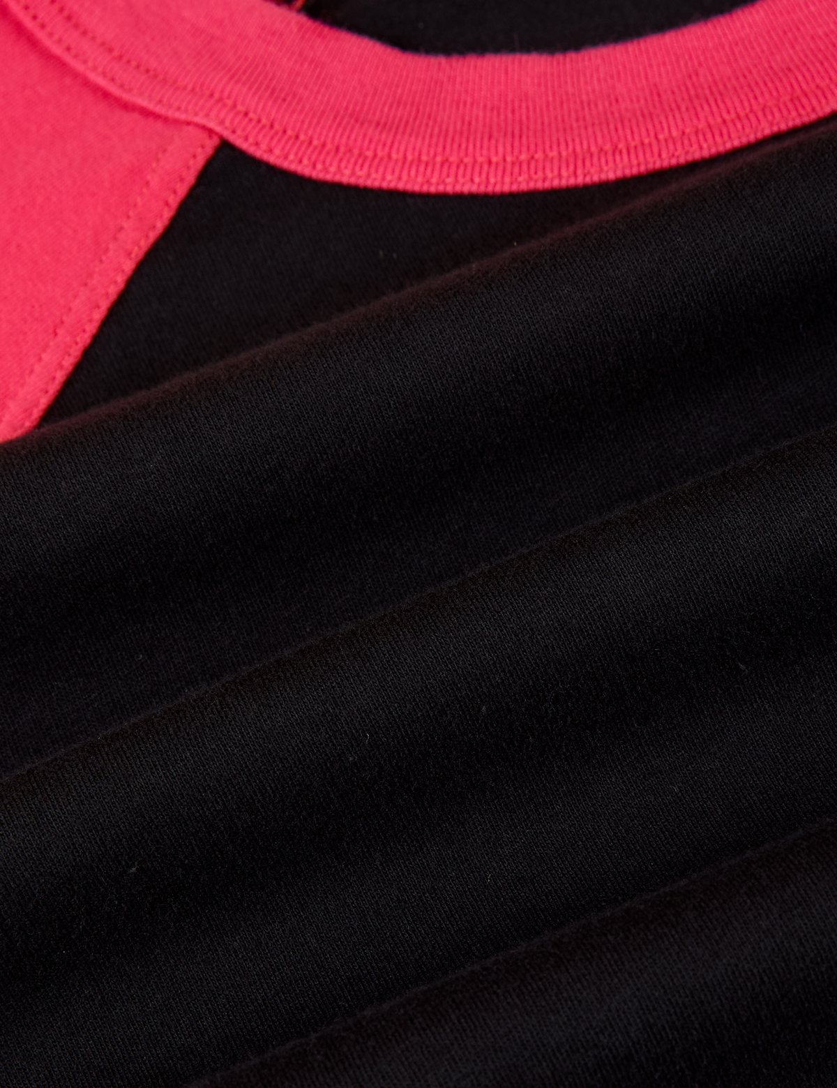 Fabric close up of the Black/Pink Colorblock Raglan Tee