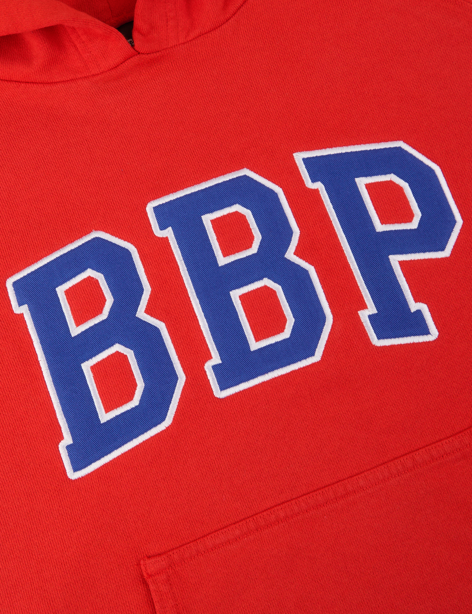 Collegiate Hoodie in Mustang Red close up of twill embroidered BBP logo in blue