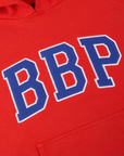 Collegiate Hoodie in Mustang Red close up of twill embroidered BBP logo in blue