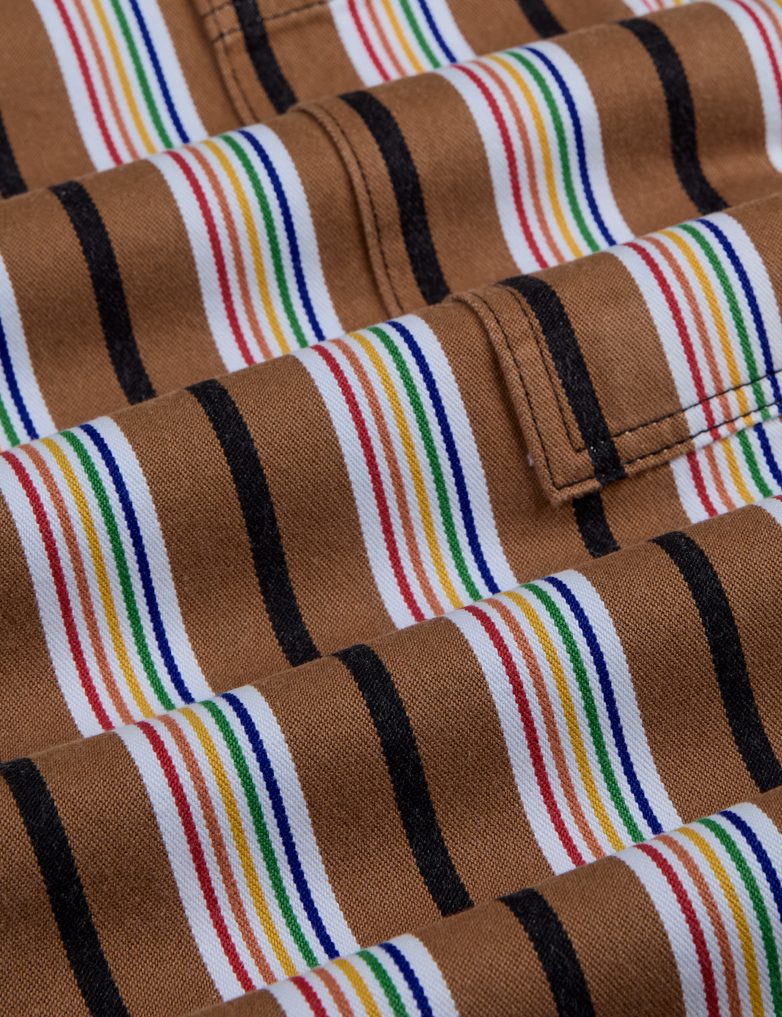 Striped Drop Pocket Pants in Retro Rainbow fabric close up. Black, white, red, orange, yellow, green and blue stripes