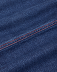 Carpenter Jeans in Dark Wash fabric detail close up with contrast red stitching.