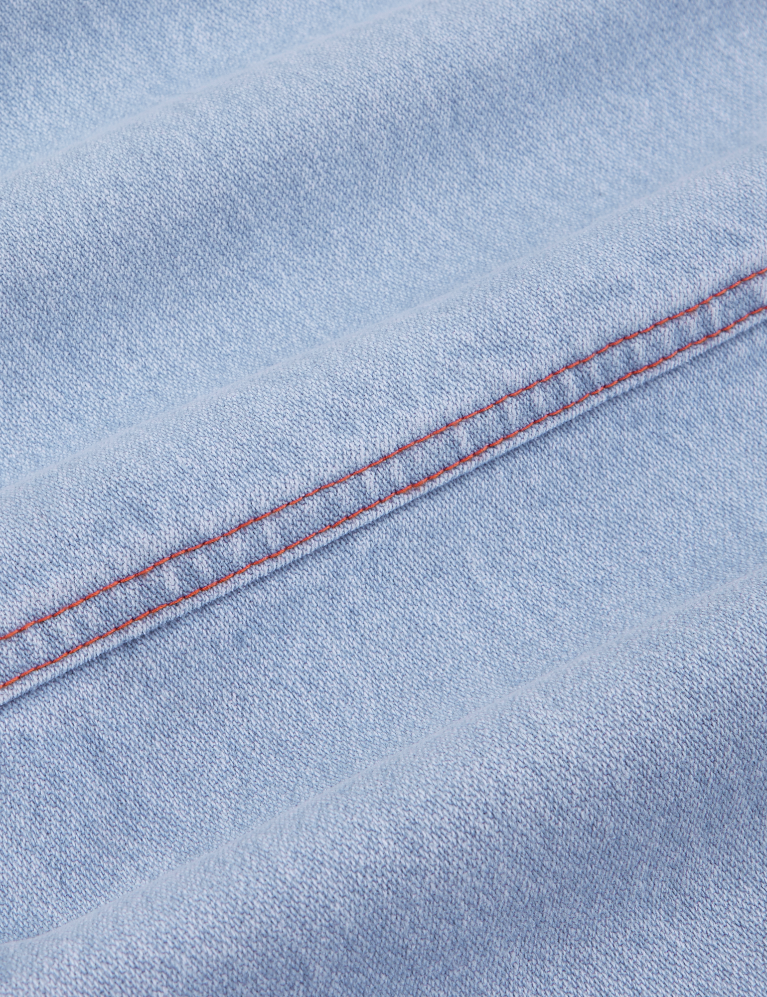 Carpenter Jeans in Light Wash fabric detail close up with red contrast stitching