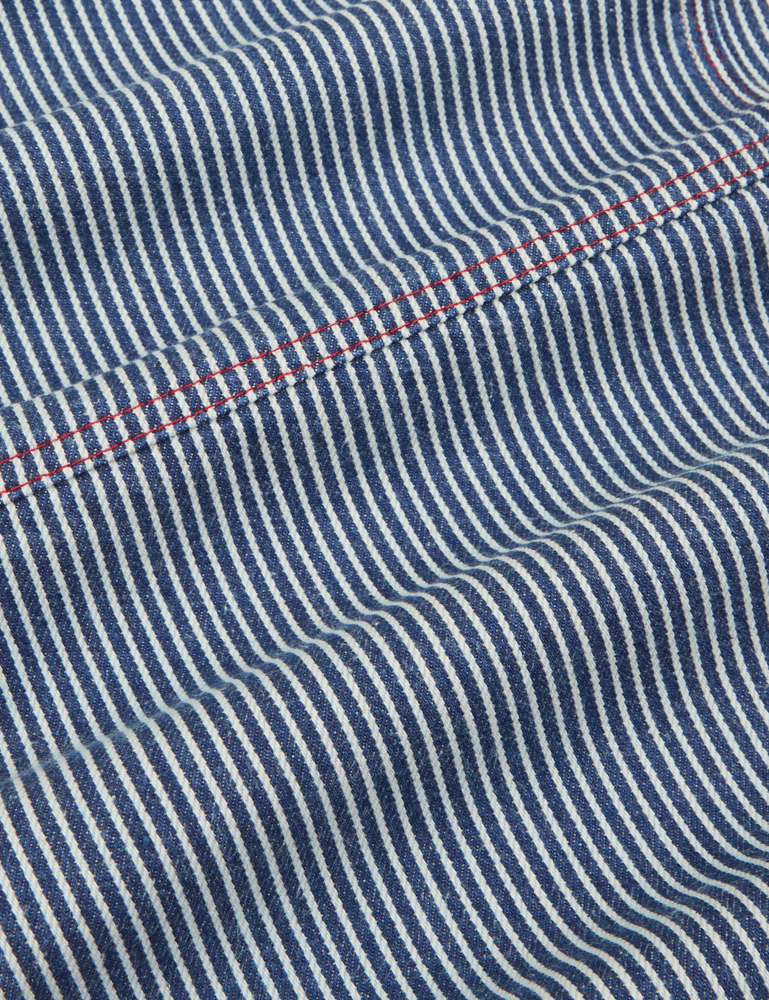 Carpenter Overalls in Railroad fabric detail close up. Red stitching.