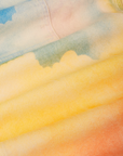 Airbrush Overalls fabric detail close up of airbrushed clouds in yellows, oranges, pinks and blues