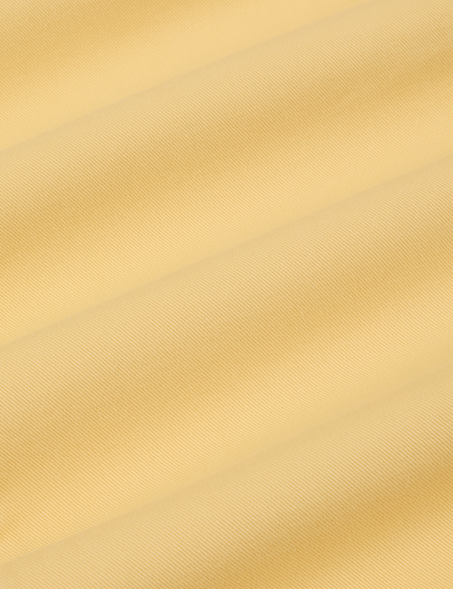 Short Sleeve Jumpsuit in Butter Yellow fabric detail close up