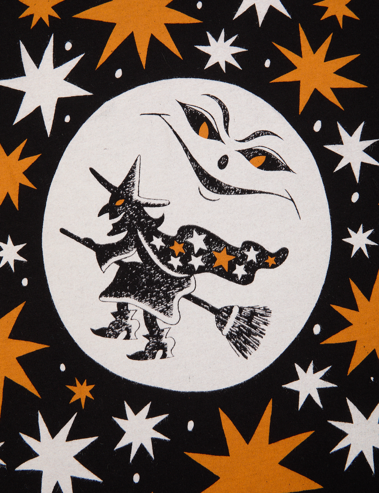 Halloween Organic Tee in Moon close up. White moon with a flying witch. Orange and white stars surround the image.