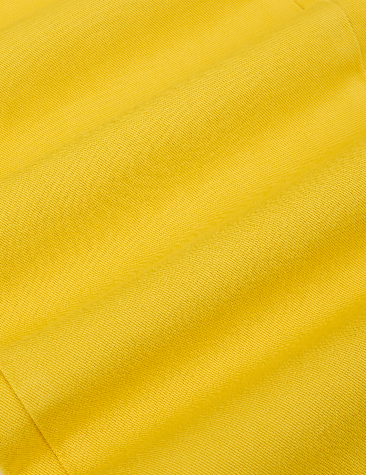 Long Sleeve Jumpsuit in Golden Yellow fabric detail close up