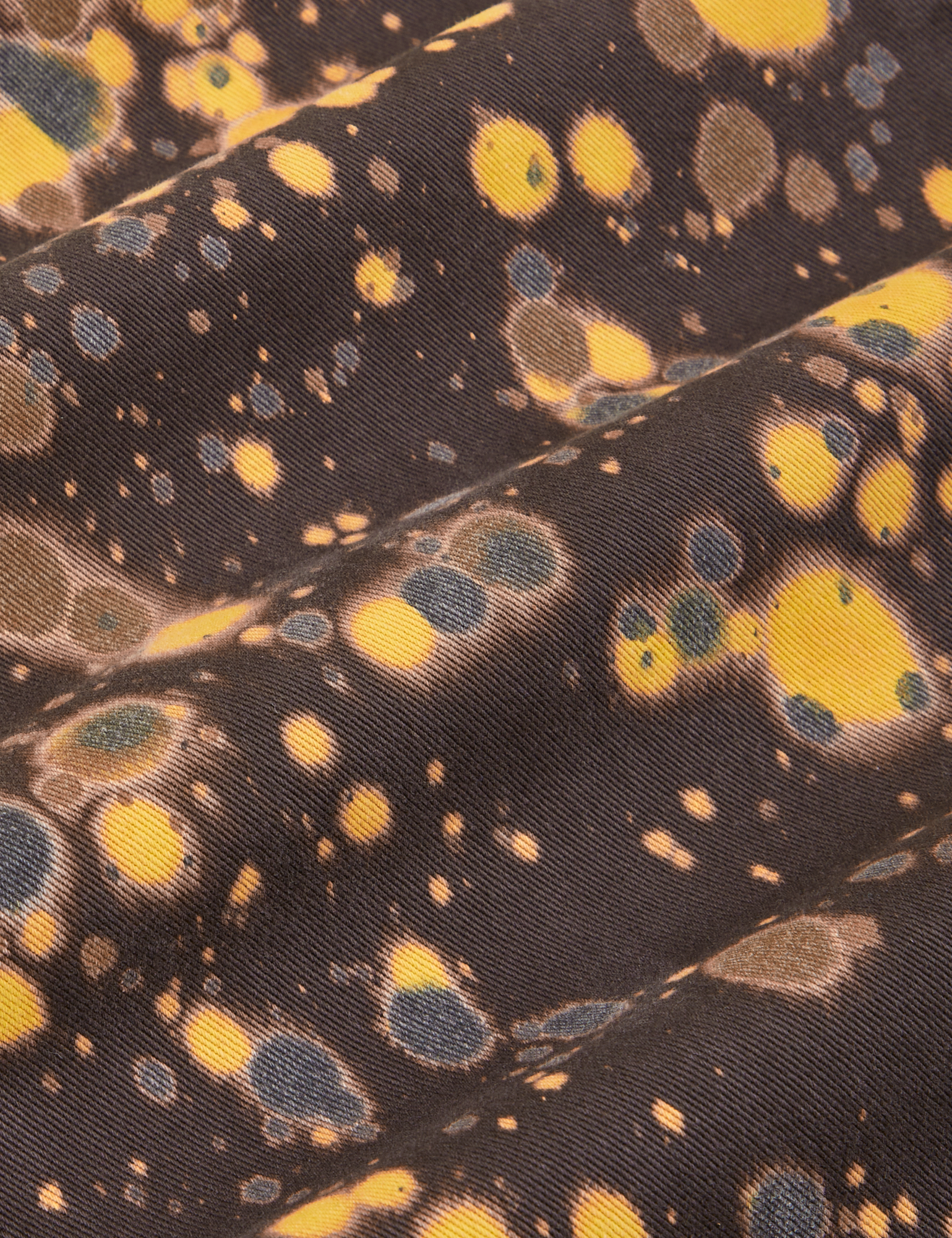 Marble Splatter Work Pants in Espresso Brown fabric detail close up. Splatter paint in yellow, brown and black.