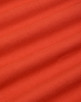 Mid-Rise Pleated Trousers in Chili Red fabric detail close up