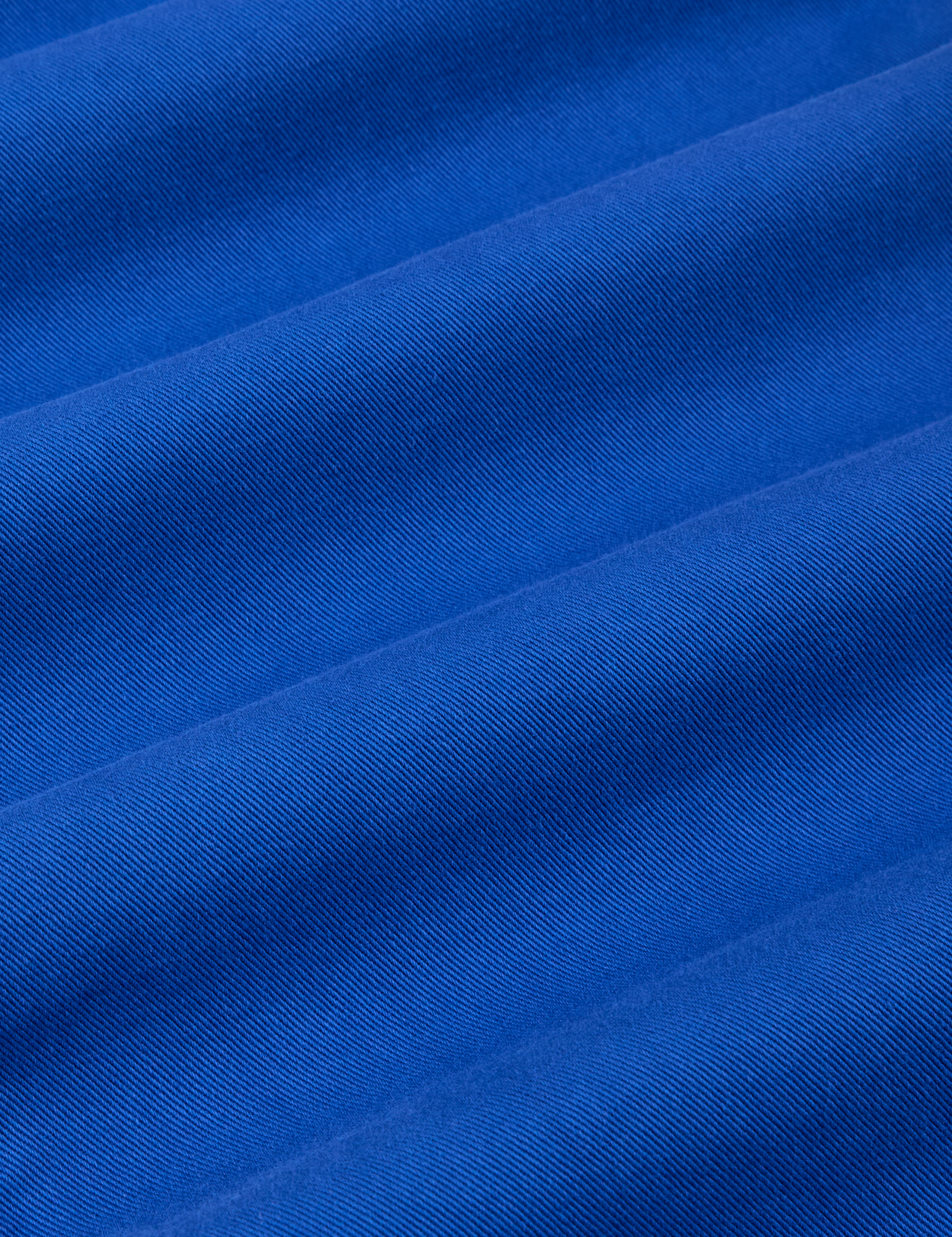 Mid-Rise Pleated Trousers in Royal Blue fabric detail close up