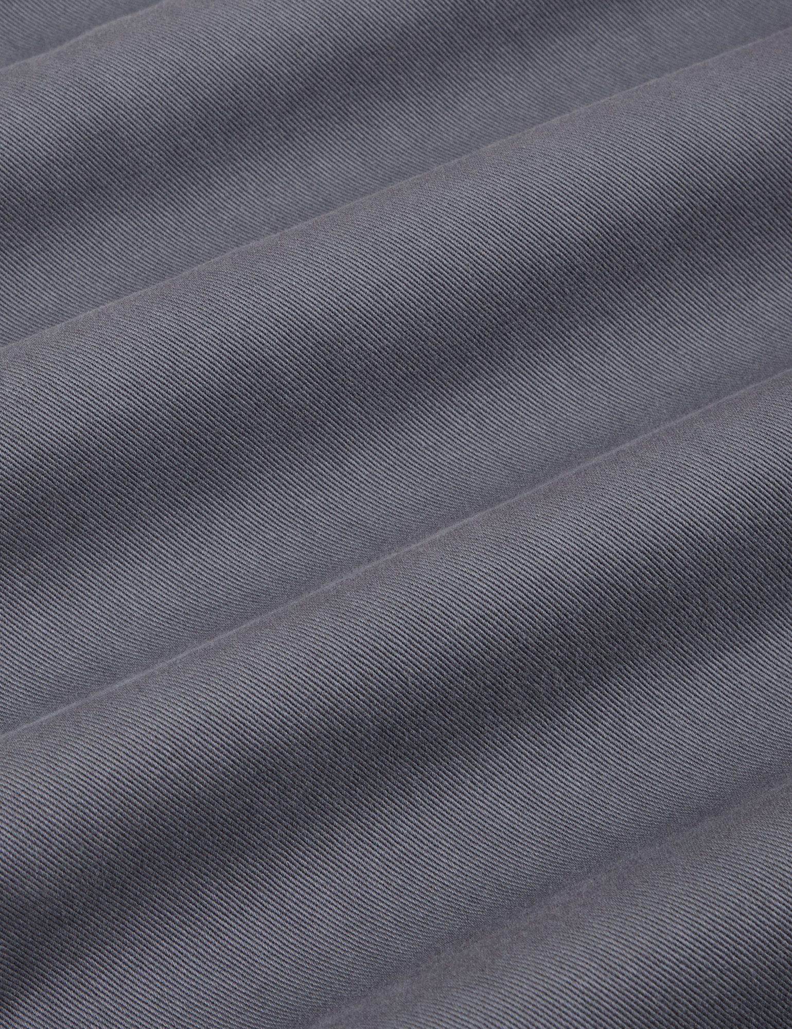 Mid-Rise Pleated Trousers in Slate Grey fabric detail close up