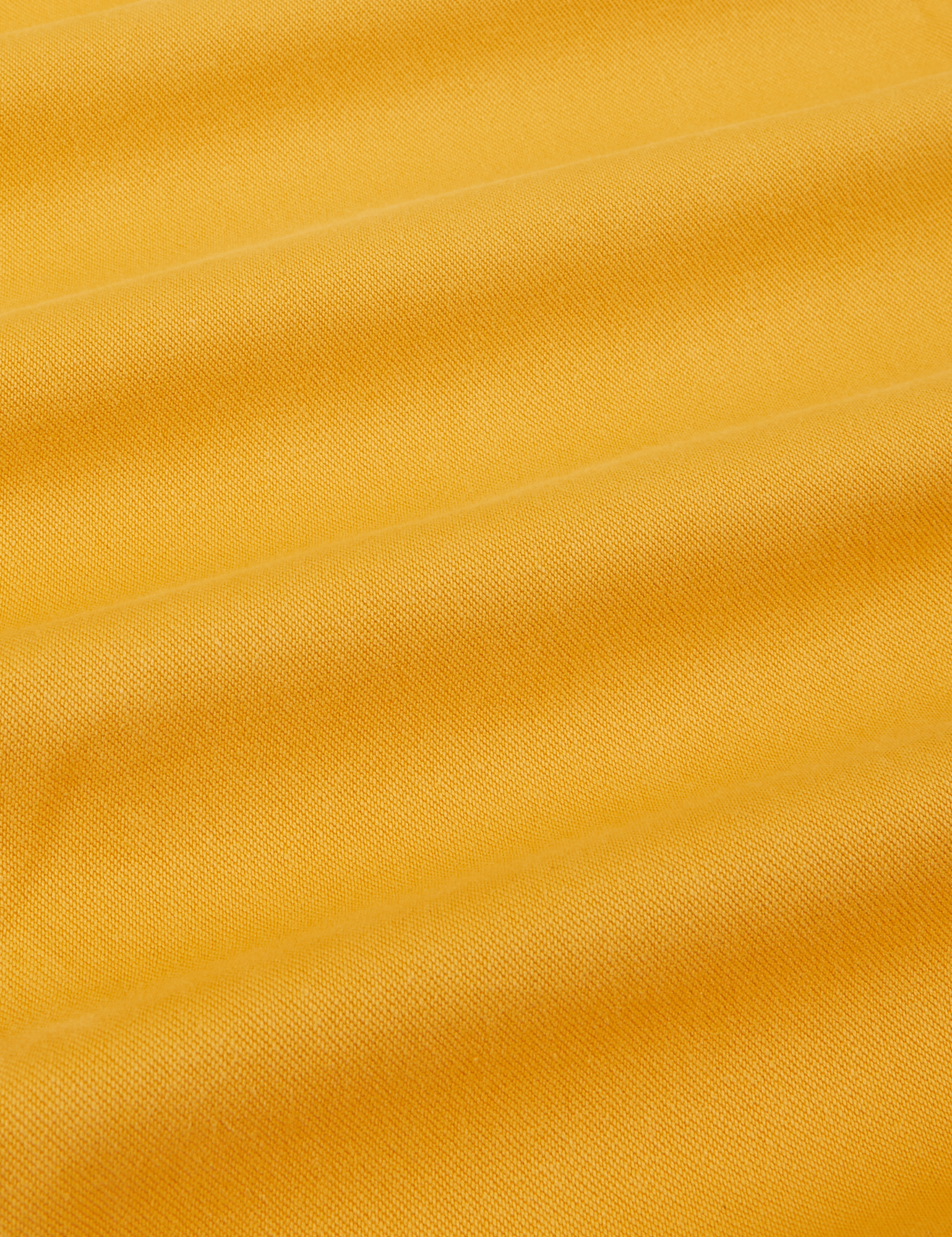 Organic Trousers in Mustard Yellow fabric detail close up
