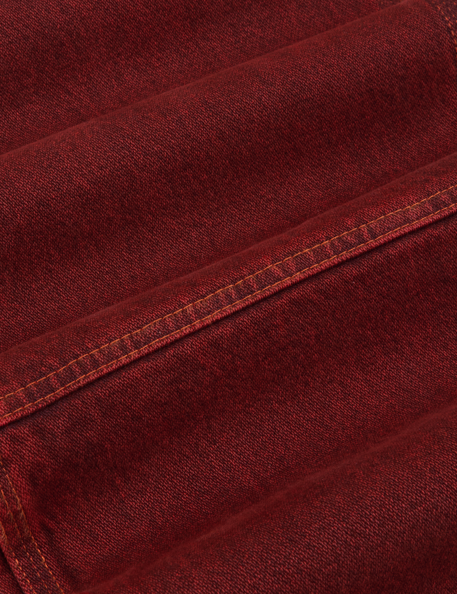 Overdyed Carpenter Jeans in Mustang Red fabric detail close up