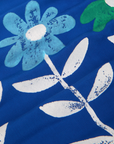 Paintstamped Pantry Button-Up in Daisy fabric close up. Baby blue flower with white leaves and stem