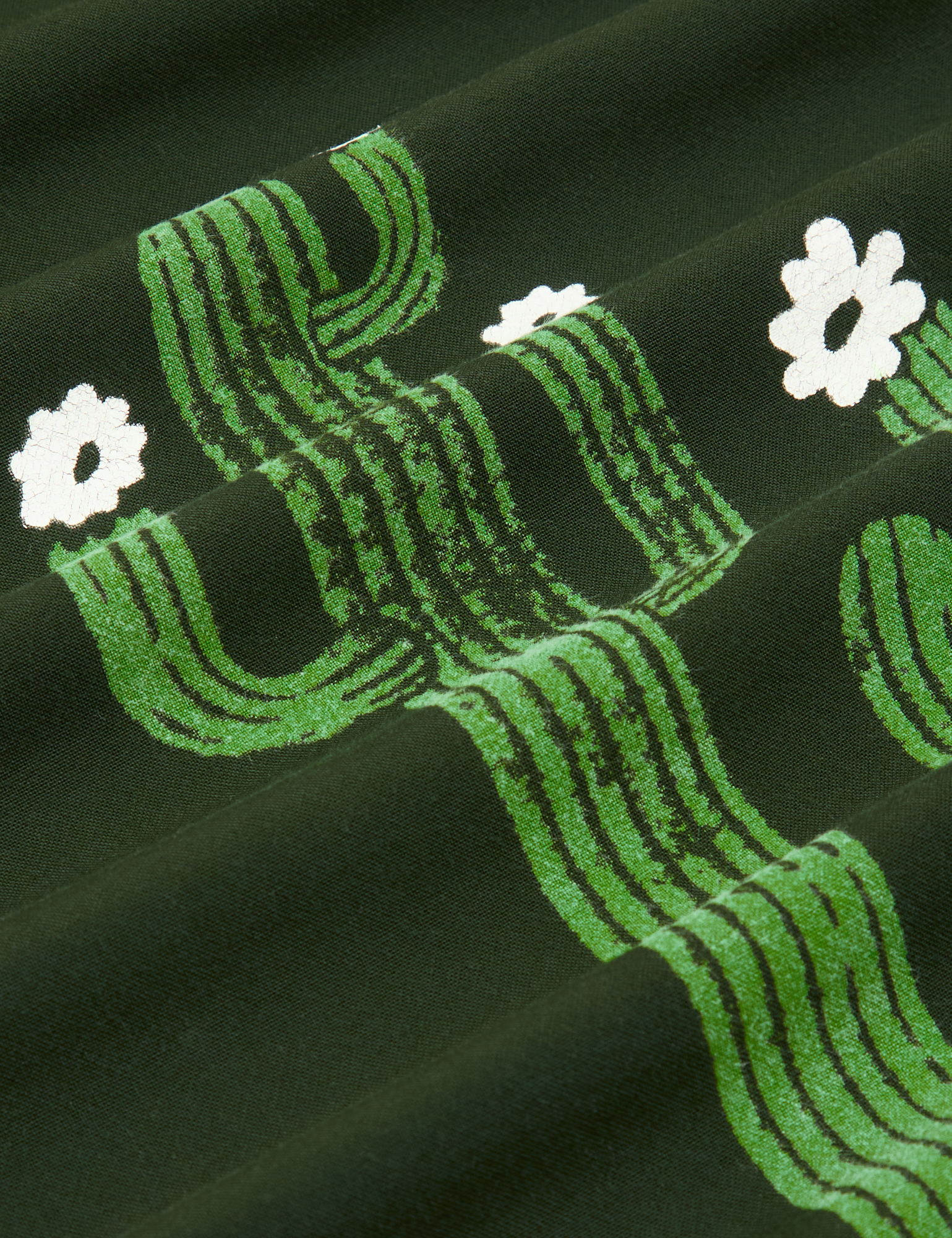 Paintstamped Pantry Button-Up in Cactus fabric detail close up. Paintstamped cactus in green with white flowers