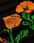 Close up of paintstamped poppies in orange and green on black work pants