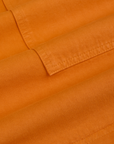 Longline Work Shorts in Creamsicle Orange fabric detail close up