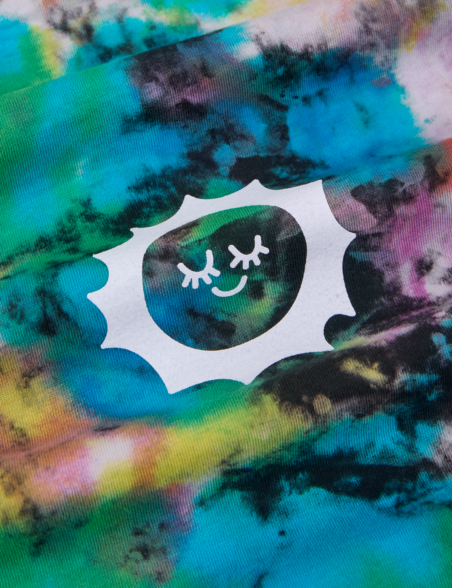 Classic Tee in Rainbow Magic Waters fabric detail close up. Sun Baby logo stamped in white