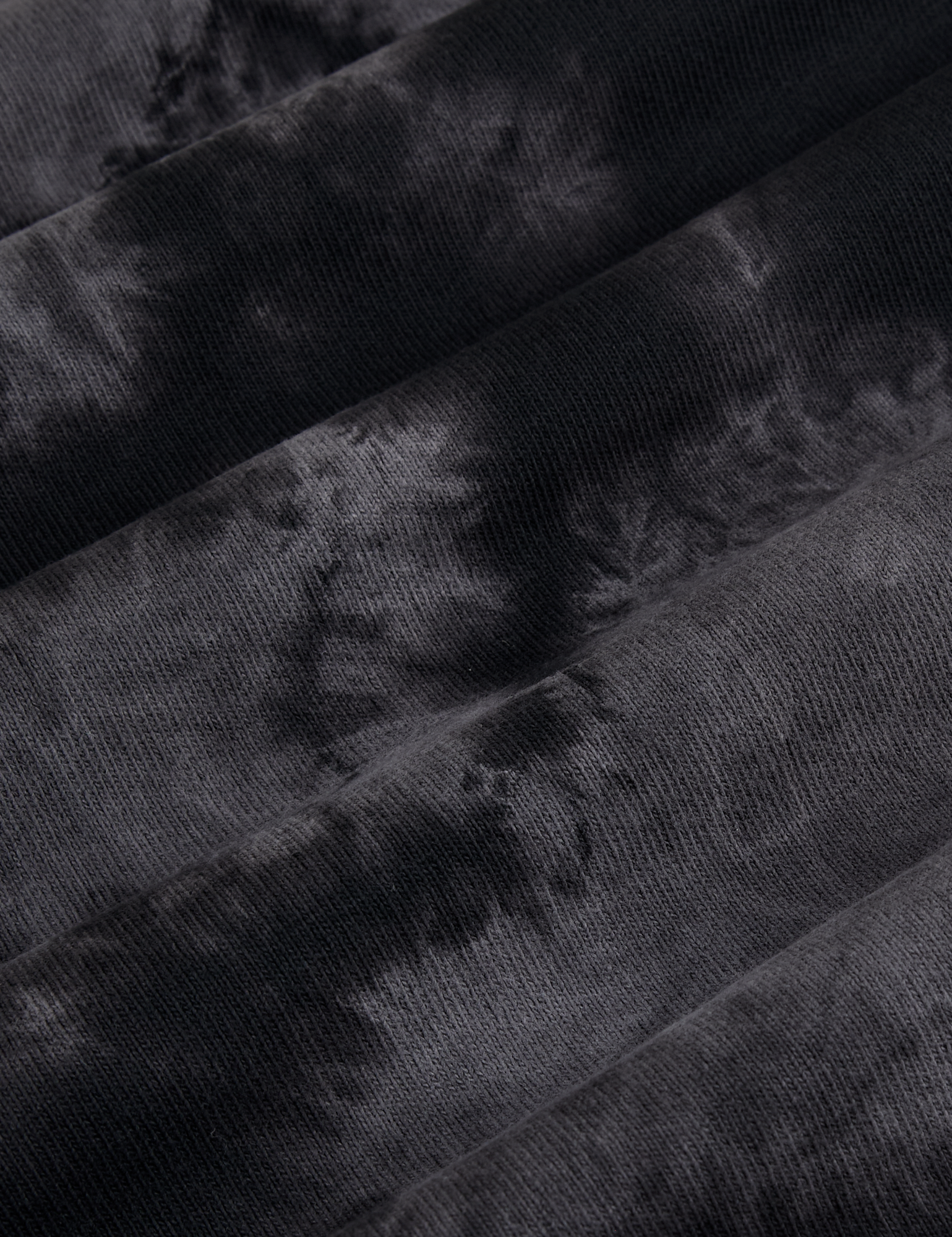 Magic Waters Long Sleeve Burly Tee in Black fabric detail. Tie dyed in black and grey