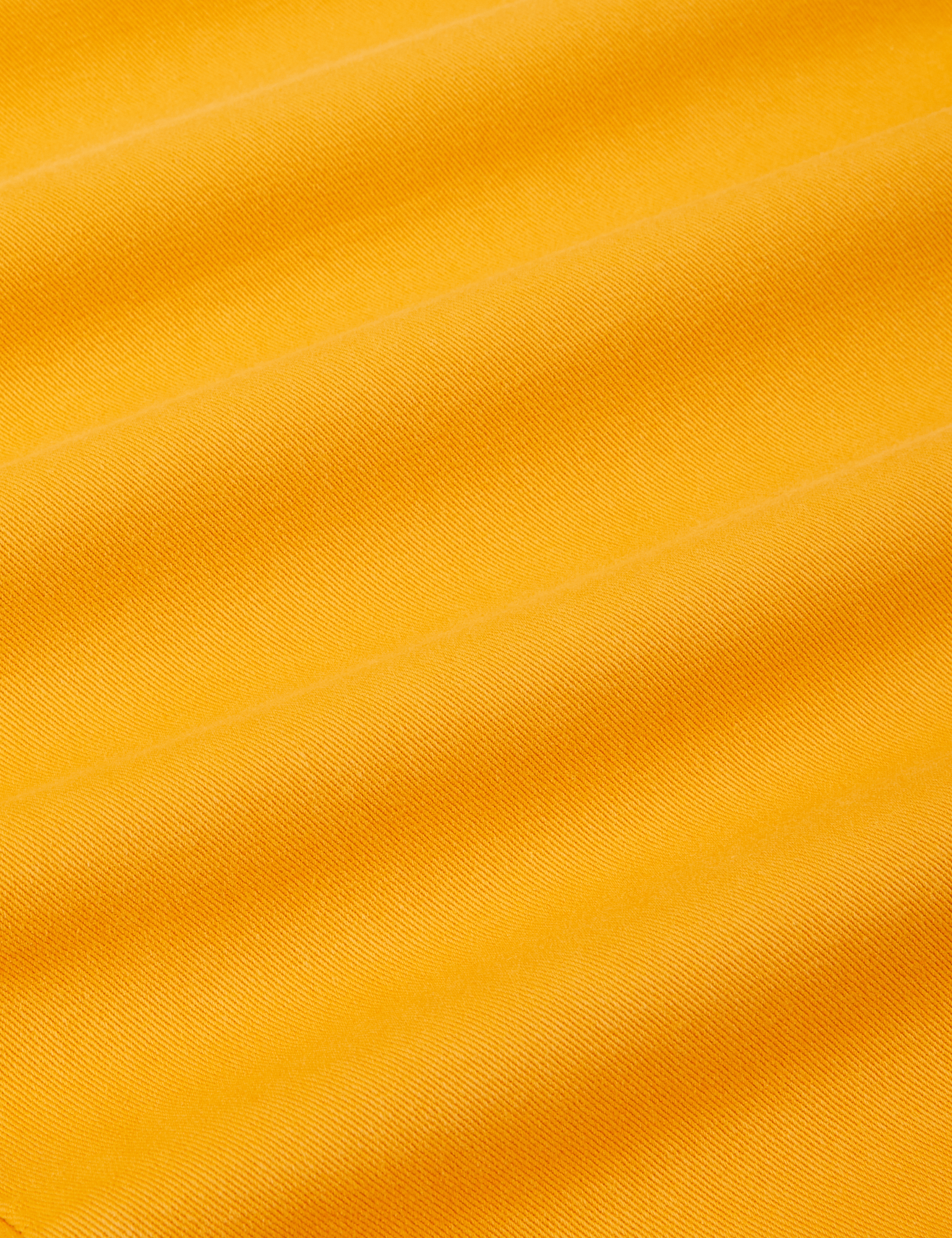 Short Sleeve Jumpsuit in Mustard Yellow fabric detail close up