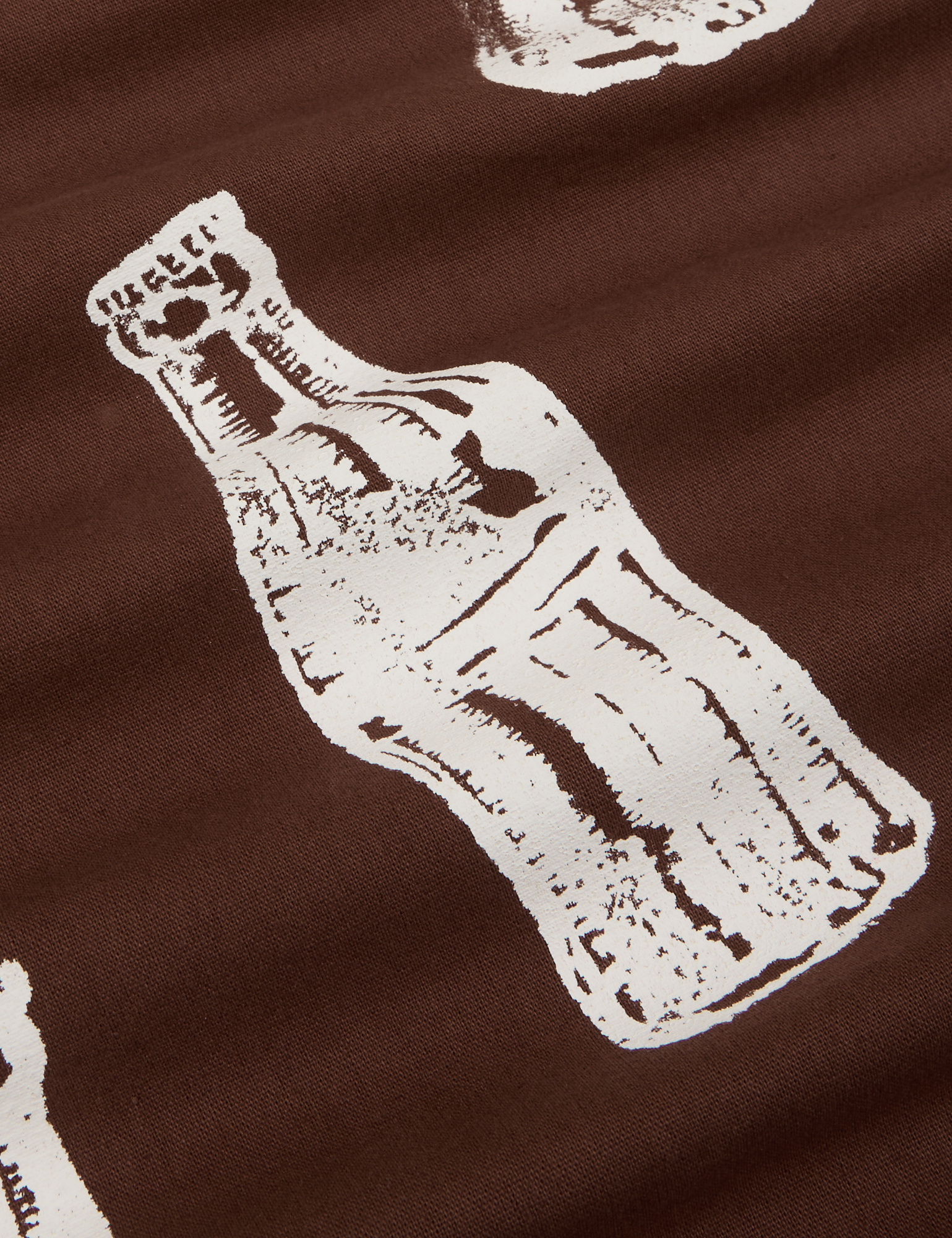 Soda Bottle Pantry Button-Up in Fudgesicle Brown close up of white paintstamped bottle