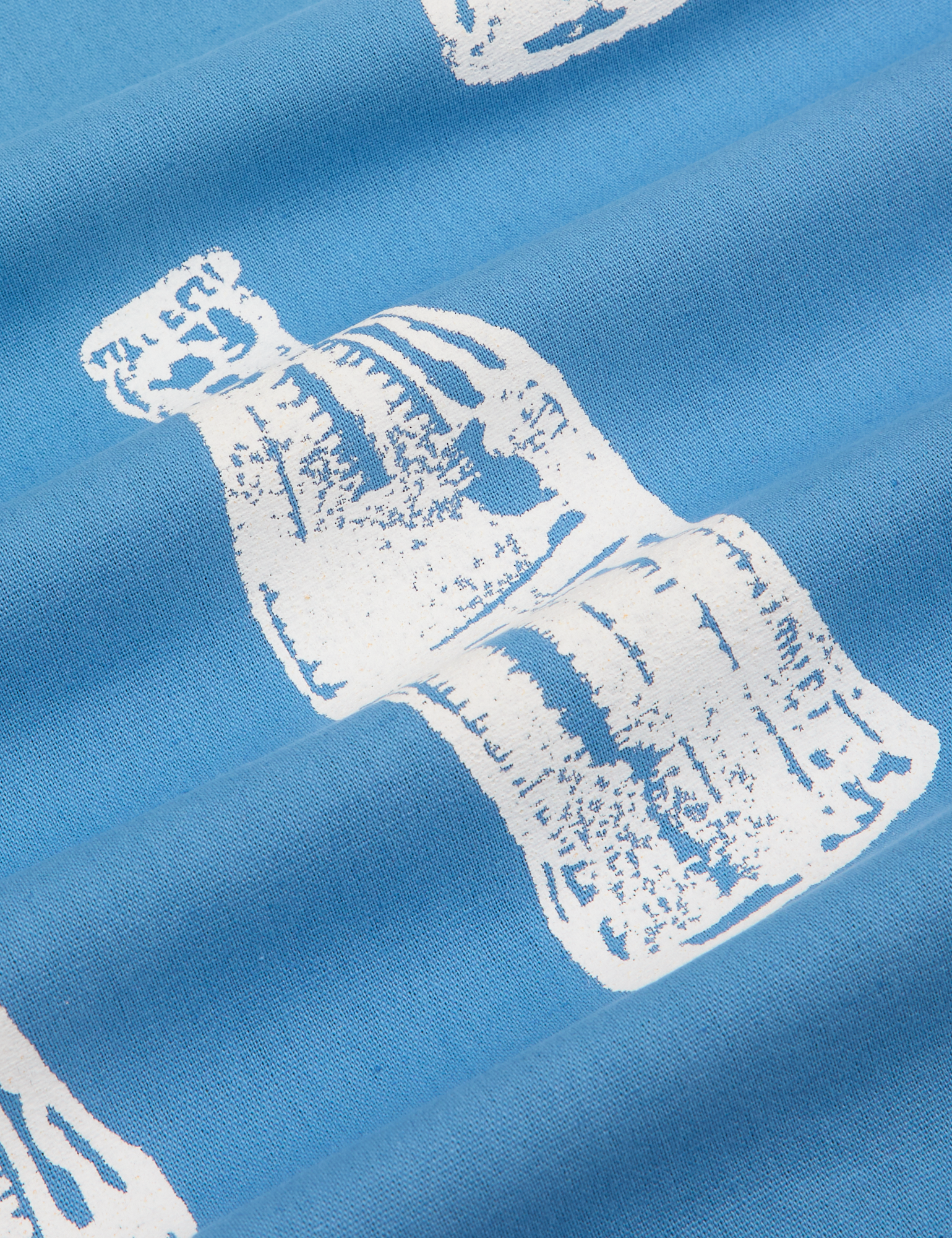 Soda Bottle Pantry Button-Up in Greek Blue close up of white paintstamped bottle