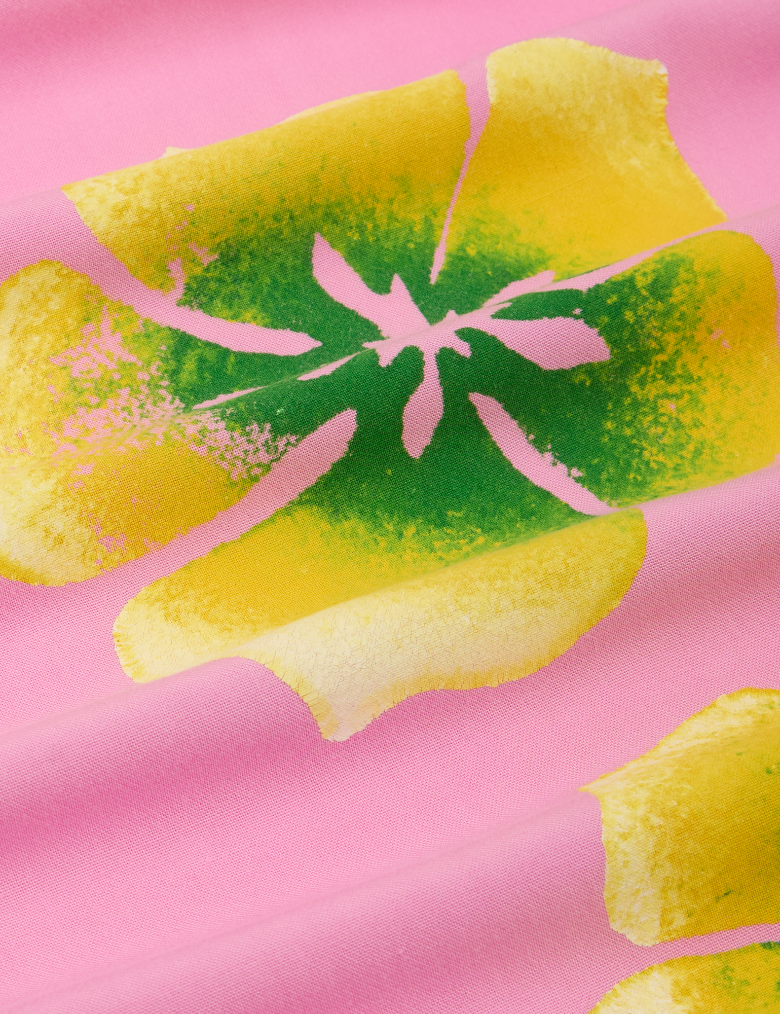 Paintstamped Pantry Button-Up in Bubblegum Pink fabric detail close up. Yellow and green paintstamped flowers.